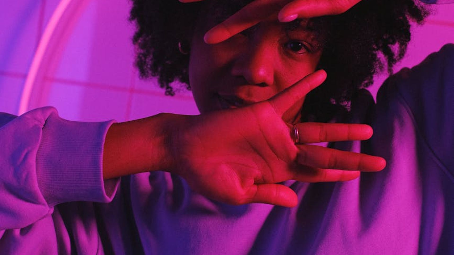 Person doing dynamic movements in a neon light studio